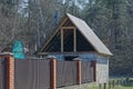 Long brown private fence and unfinished rural brick house Royalty Free Stock Photo