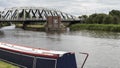 Long canal boat inn front of black & white bridge Royalty Free Stock Photo