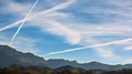 Chemtrails over mountains Royalty Free Stock Photo