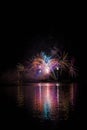 Long colorful tails of fireworks over surface Brno`s Dam with lake reflection Royalty Free Stock Photo