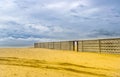 A long concrete fence on the sea beach Royalty Free Stock Photo