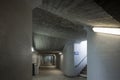 Long concrete pedestrian corridor under the train station with the staircase