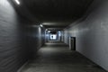 Long concrete pedestrian underpass passing under the train station in Melide, Switzerland