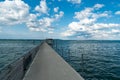 Long concrete pier in Altnau leading out into Lake Constance under an expressive summer sky