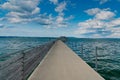 Long concrete pier in Altnau leading out into Lake Constance under an expressive summer sky