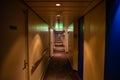 Long corridor of cruise ship, yellow walls and blue doors