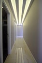 A long corridor with doors at the sides and a light at the end of the corridor Royalty Free Stock Photo
