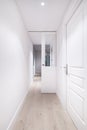 A long corridor of a house with light wooden flooring Royalty Free Stock Photo