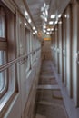 A long corridor inside a passenger rail car. Geometric lines, blurred