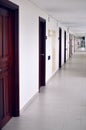 Long corridor with many doors located on outdoor veranda Royalty Free Stock Photo