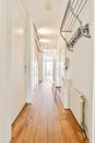 A long corridor with in modern apartment with wooden floor and white walls Royalty Free Stock Photo
