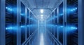 A long corridor in a modern data center with rows of servers illuminated by blue lights on both sides, featuring a concrete floor Royalty Free Stock Photo