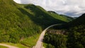 a long country road on top of mountains surrounded by trees Royalty Free Stock Photo