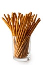 Long crunchy salty pretzel sticks in glass isolated on white.