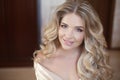 Long curly hair. Beautiful blond happy smiling bride girl lookin Royalty Free Stock Photo