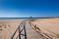 Long curve wooden boardwalk footpath of beach in Canos Meca