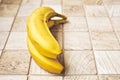 Two ripe bananas on a checkered wooden surface