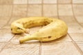 Two ripe bananas on a checkered wooden surface