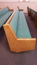 Long cushioned church pew Royalty Free Stock Photo