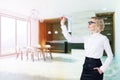 Dark wooden table in panoramic kitchen, woman