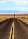 Long desert highway leading into Death Valley National Park, USA