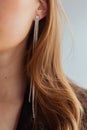 Long diamond earring close-up, blond woman, neck perfect skin Royalty Free Stock Photo