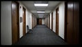 Long Dimly Lit Hotel Corridor with Closed Doors Royalty Free Stock Photo