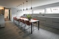 Long dining table with red chairs in an office building