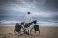 Long Distance Cyclist on beach with Bicycle