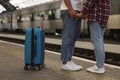 Long-distance relationship. Couple holding hands on platform of railway station, closeup Royalty Free Stock Photo