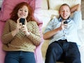 Long distance relationship, phone and couple in a bed for chat, bond or communication in different homes. Smartphone