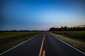 Long distant road yellow lines clear deep dark blue sky country rural Georgia Royalty Free Stock Photo