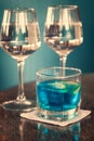 Long drink with blue curacao and two glasses of rosÃÂ© wine