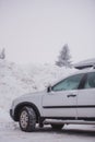 Car at the skiing resort. Wooden houses.