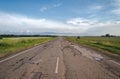 Long driveway in field, rural road, landscape with clouds Royalty Free Stock Photo