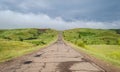 Long driveway in hills, storm landscape with clouds Royalty Free Stock Photo