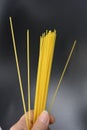 Long dry vermicelli, Italian pasta spaghetti from hard wheat varieties in packs on an interesting black background