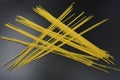 Long dry vermicelli, Italian pasta spaghetti from hard wheat varieties in packs on an interesting black background