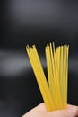 Long dry vermicelli, Italian pasta spaghetti from hard wheat varieties in packs on an interesting black background