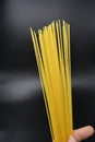 Long dry vermicelli, Italian pasta spaghetti from hard wheat varieties in packs on an interesting black background