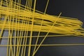 Long dry vermicelli, Italian pasta spaghetti from hard wheat varieties in packs on an interesting black background