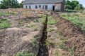 Long earthen trench dug to lay pipe. Royalty Free Stock Photo