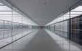 Long empty modern office hallway with reflective floor and glass walls Royalty Free Stock Photo