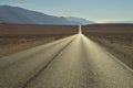 Long empty desert road Death Valley National Park Royalty Free Stock Photo