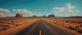 EMPTY DESERT ROAD LEADING TO MOUNTAIN IN THE DISTANCE Royalty Free Stock Photo