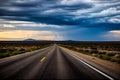 A long, empty Texas highway stretching through the desert with a dramatic sky overhead Royalty Free Stock Photo