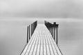 long empty wood fishing dock on a foggy summer morning at the lake Royalty Free Stock Photo