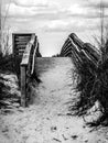 long and empty wooden foot path bridge over the marsh and water to the ocean beach Royalty Free Stock Photo