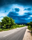 Long endless road in countryside with no traffic with clouds Royalty Free Stock Photo