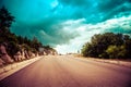 Long endless road in countryside with no traffic with clouds Royalty Free Stock Photo